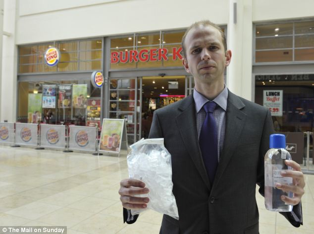 'Poor hygeine': Ice served in six out of ten of Britain's most popular high street restaurants contains more bacteria than the water found in their toilets. Reporter Ben Ellery pictured in Basigstoke, Hants., with samples from Burger King